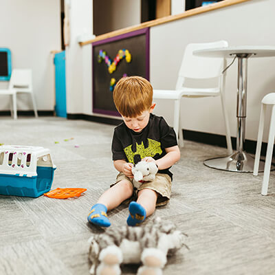 Boy playing with stuffed animal